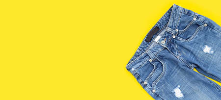 Blue jeans on yellow background.の写真素材