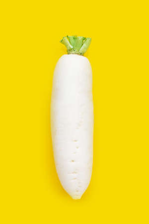 Daikon radishes on yellow background.の写真素材