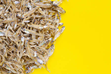 Dried anchovy on yellow background.の写真素材