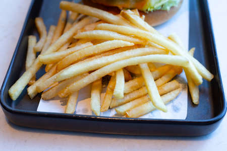 French fries on black plate