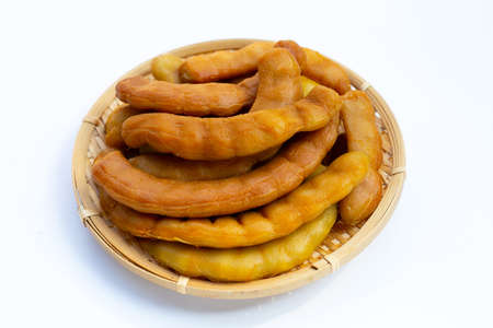Tamarind pickled fermented in round bamboo basket on white background.の写真素材