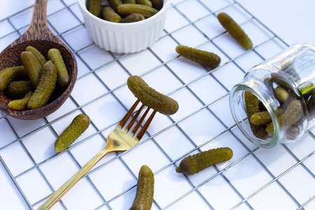 Pickled gherkins or cucumbers on white background.