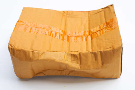 Damaged cardboard box on white background.の写真素材