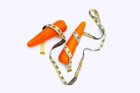 Carrot wrapped in measuring tapeの写真素材