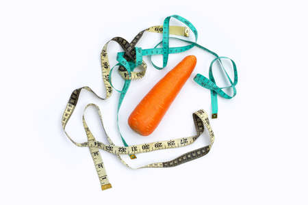Carrot wrapped in measuring tapeの写真素材