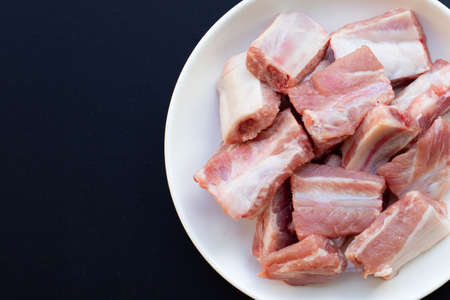 Raw pork ribs on dark backgroundの写真素材