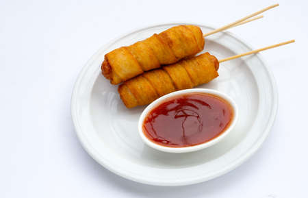 Fried dough snacks wrapped sausage on white background.