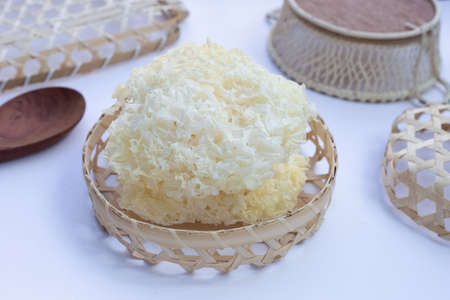 Tremella Mushroom in bamboo basket on white background.の写真素材