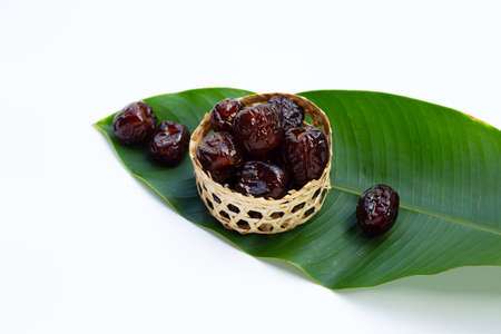 Sweet chinese jujube dessert in bamboo basket on green leaf