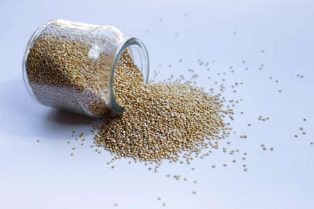 Organic Quinoa in jar on white background.の写真素材