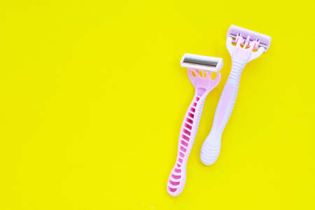 Women razors on yellow surfaceの写真素材