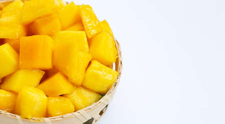Tropical fruit, Mango cube slices in bamboo basket on white background.の写真素材