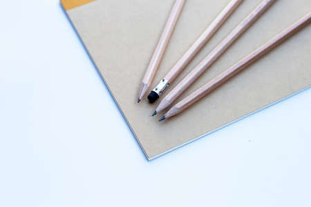 Pencil on notebooks or paper on white backgroundの写真素材