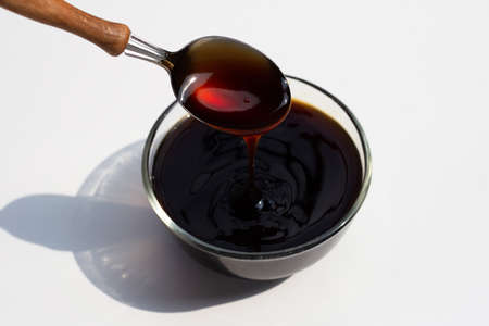 Oyster sauce in glass bowl on white background.の素材 [FY310179281066]