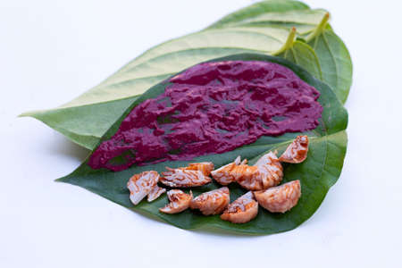Chewing betel nut, Betel nut with red cal lime powder on betel leavesの写真素材