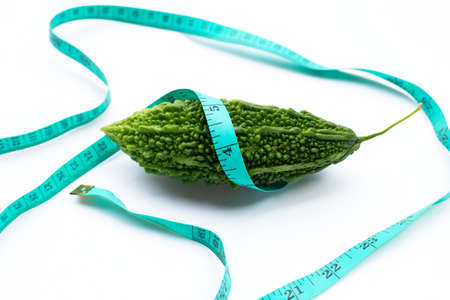Bitter gourd wrapped in measuring tapeの写真素材