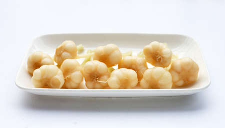 Pickled garlic in plate on white background.の写真素材