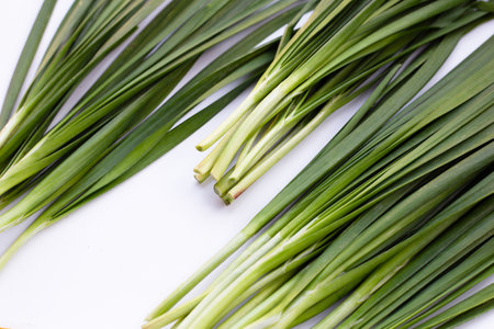 Fresh Chinese Chive leaves on white background.
