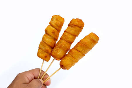 Fried dough snacks wrapped sausage on white background.の写真素材