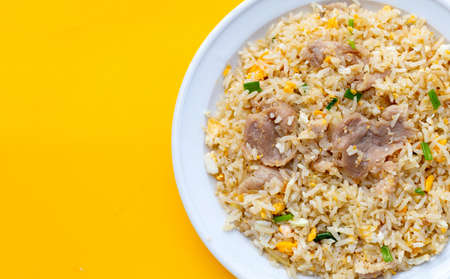Fried rice in white plate on yellow background.の写真素材