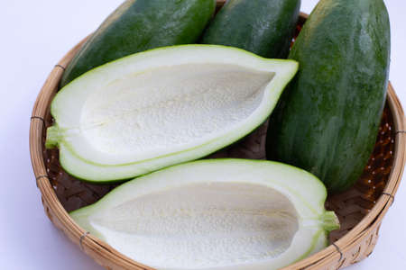 Green papaya in bamboo basketの写真素材