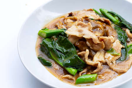Fried flat noodle with pork and kale in gravy sauceの写真素材