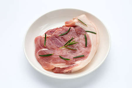 Pork meat in plate on white background.の写真素材