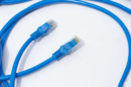 LAN network connection  blue cables on white background.の写真素材