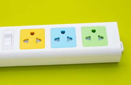Electrical power strip on green background.
