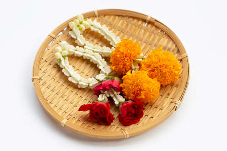 Crown flower and Jasmine garland with marigold, rose in round bamboo basket