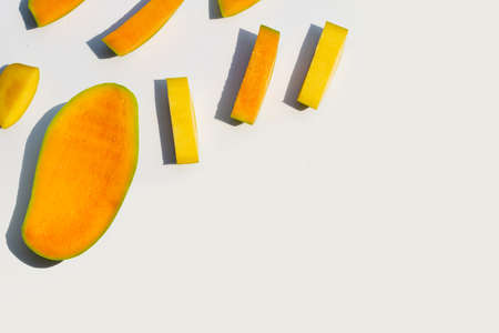 Mango cut pieces on white background.の写真素材