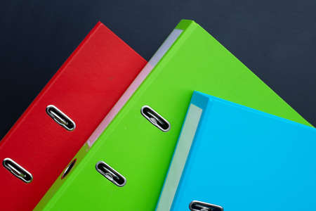 Office folders on dark background.