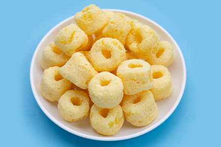Roller corn snack on blue background.