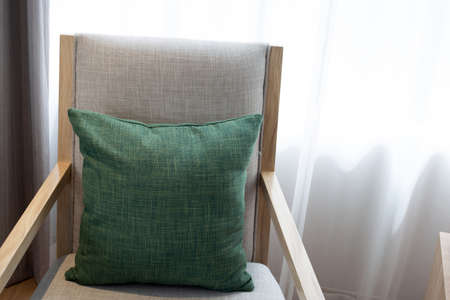 Green pillows in  chair,  Curtains backgroundの写真素材