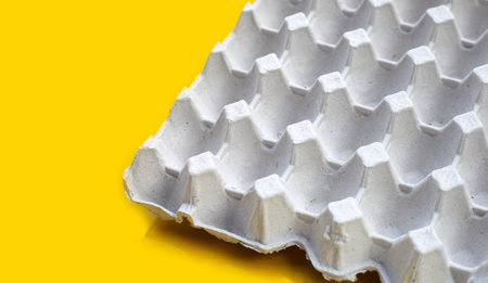 Egg crate on yellow background.の写真素材