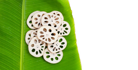 Lotus root on banana leaf on white background