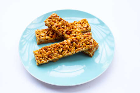 Peanut bar with almonds on whiteの写真素材