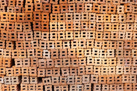 Stack of red bricks, orange clay bricksの写真素材