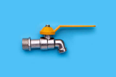 Faucet on cement on blue background