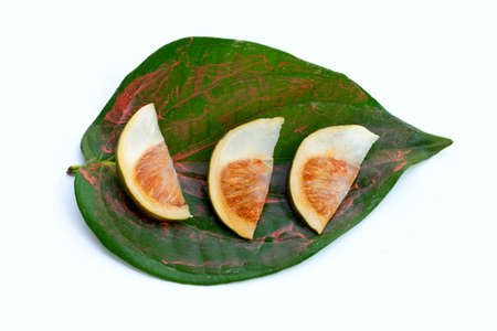 Chewing betel nut, Betel nut with cal lime powder on betel leaves