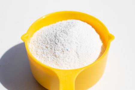 Detergent powder with measuring spoon for clothes washing. Laundry concept.の写真素材