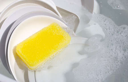 Dish washing, Dirty dishes soaking in kitchen sink.の写真素材