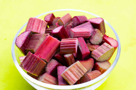 Fresh rhubarb on green background.