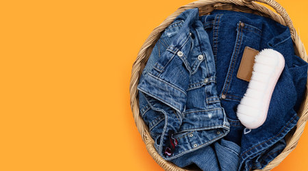 Blue jeans in laundry basketの写真素材