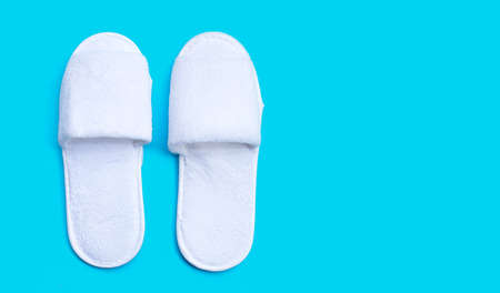 Hotel slippers on blue background. Copy spaceの写真素材