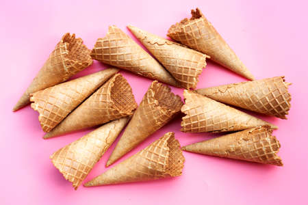 Empty ice cream cone on pink background.の写真素材