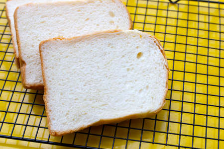 Stack of sliced bread on metal cooling rack