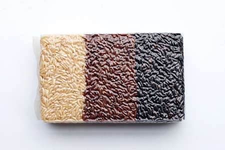 Black, brown and white rice in plastic bag