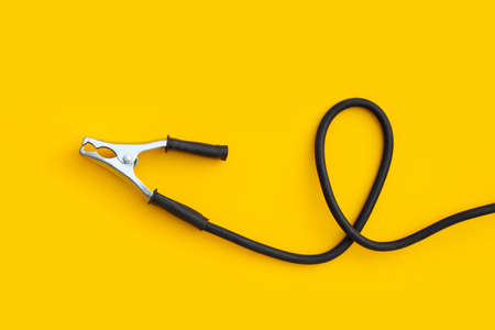 Welding ground clamp on yellow background.の写真素材