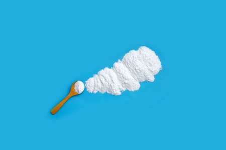 Baking soda on blue background.